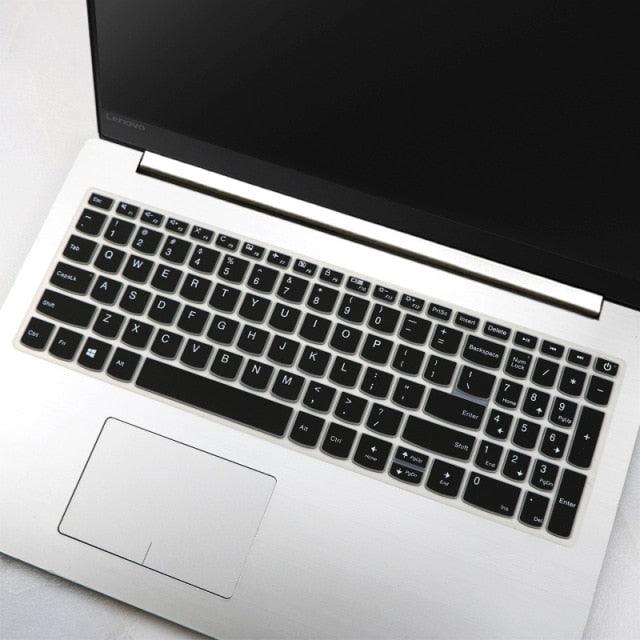 Laptop with black keyboard cover on a light gray surface