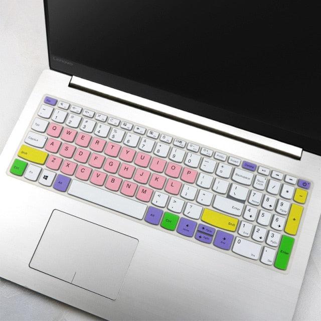 Laptop with a colorful keyboard cover on a light surface