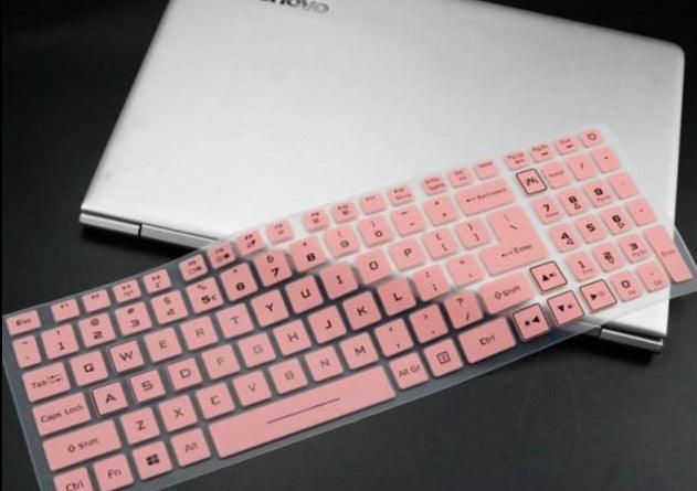 Pink keyboard cover on a laptop with a black background