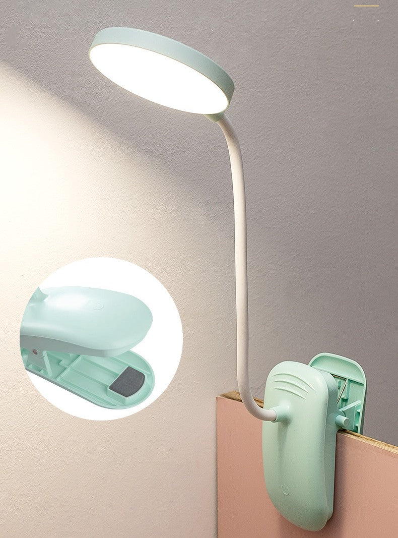 Light blue lamp with a clip on a gray background