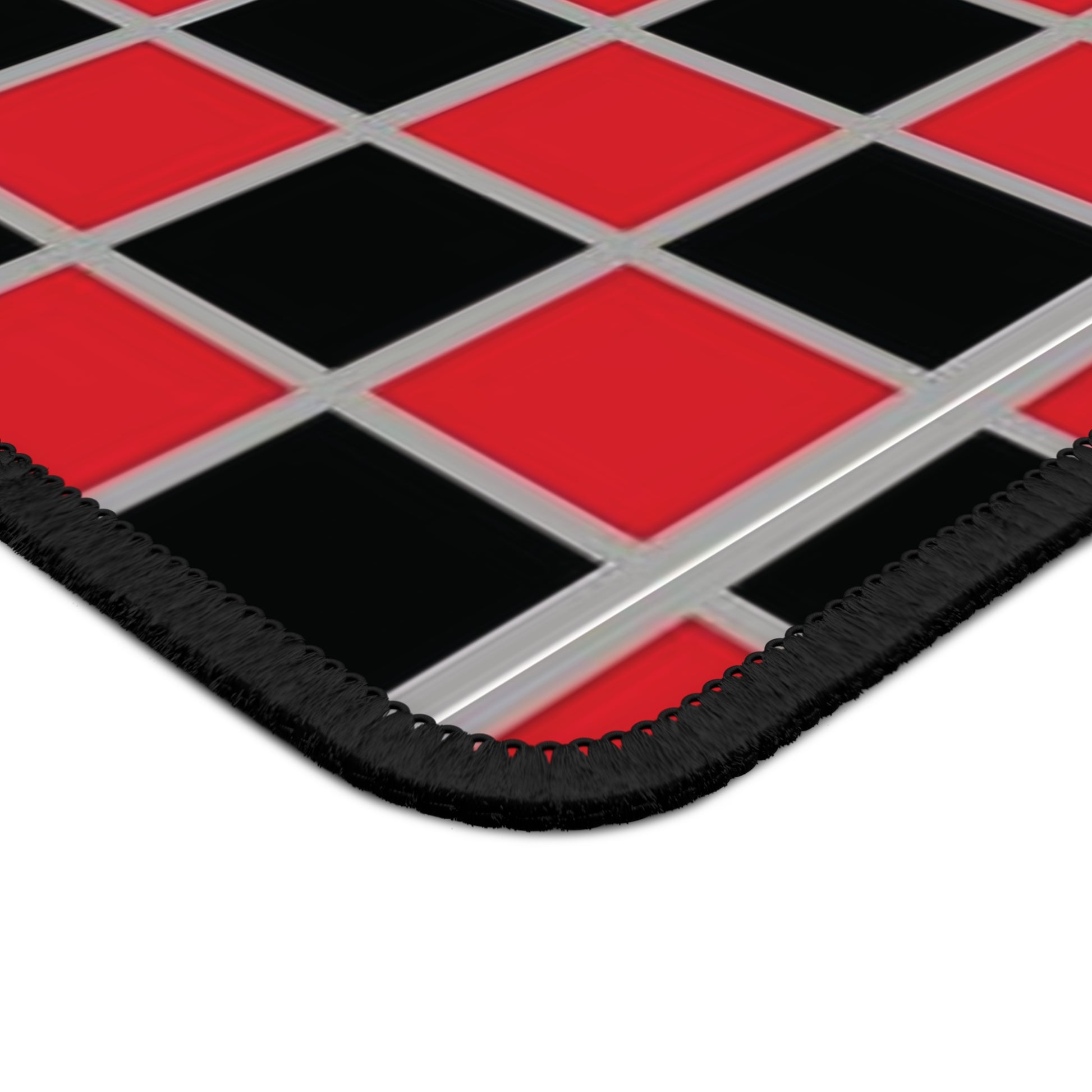 Checkered mat with red and black squares on a white background