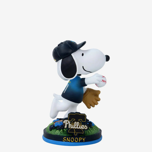 Snoopy figurine in a Phillies baseball uniform with a glove and ball, on a white background