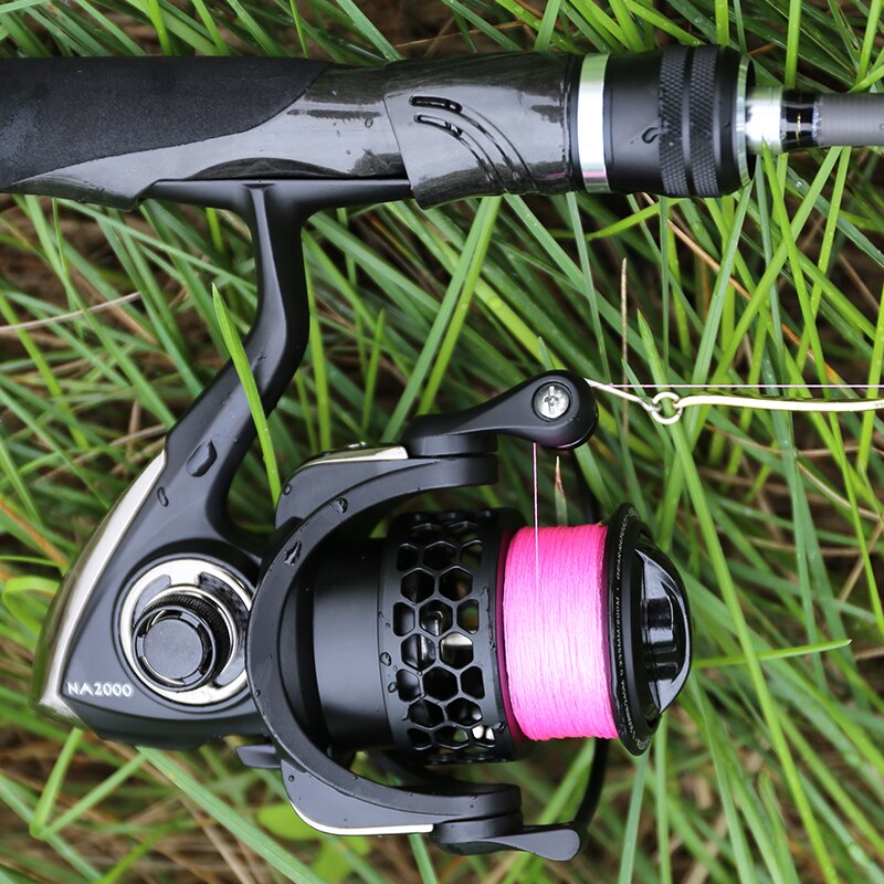 Fishing rod and reel with pink line on grass