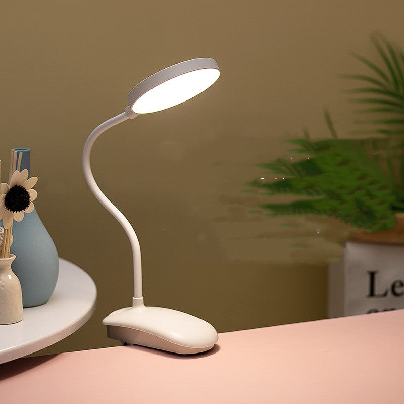 White LED desk lamp on a surface with a blurred background