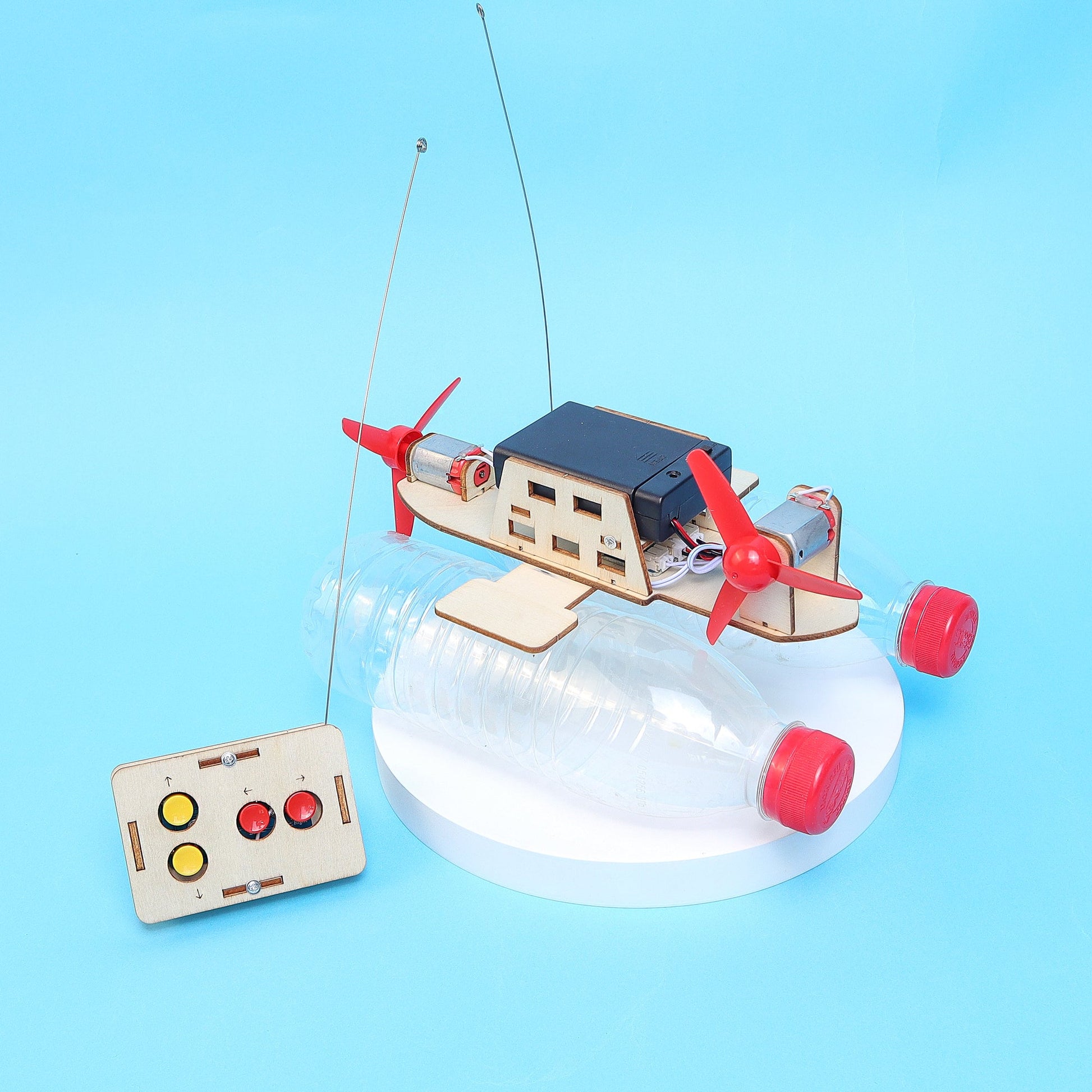 Toy boat model on a clear base with a blue background