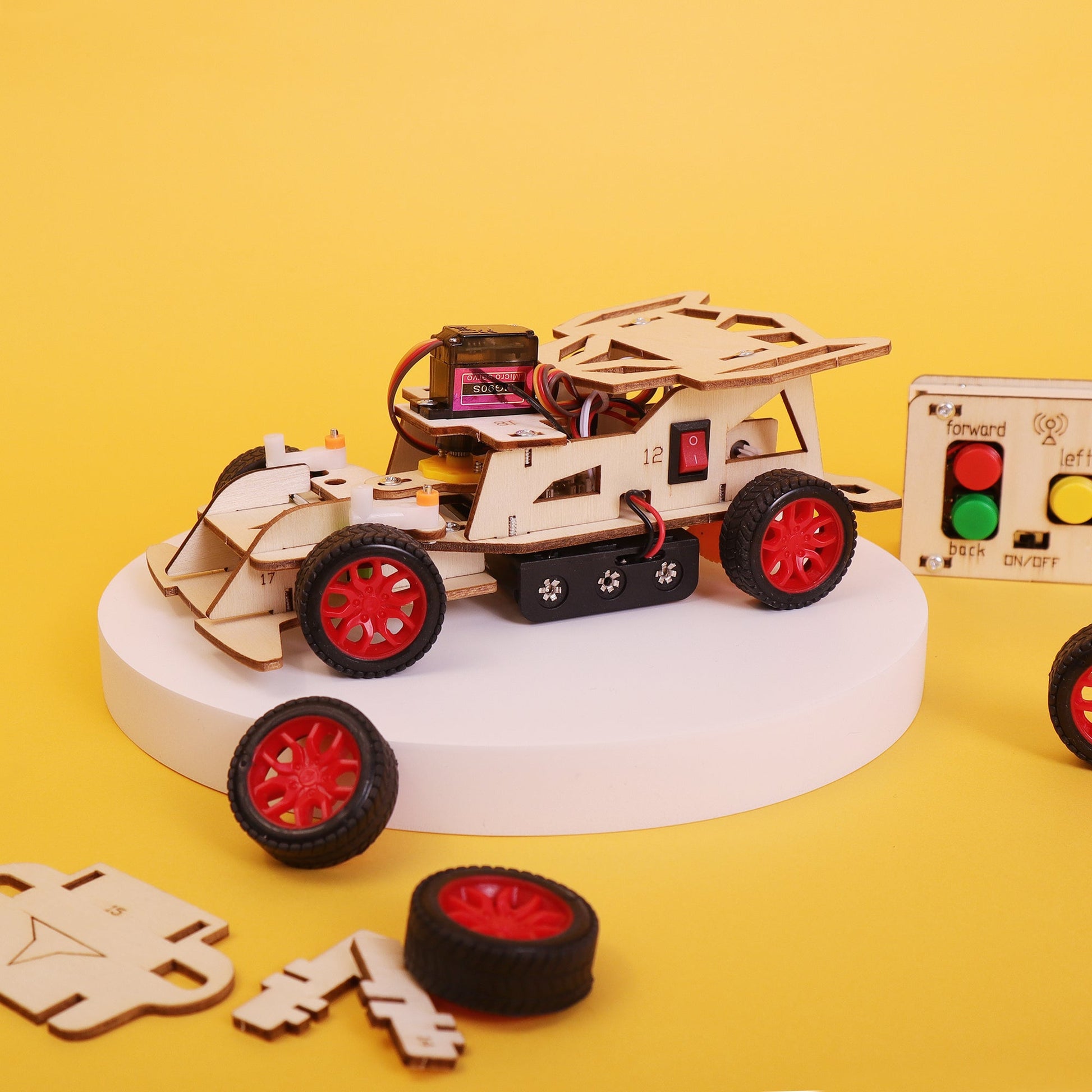 Wooden robot model on a yellow background with control panel and wheels.