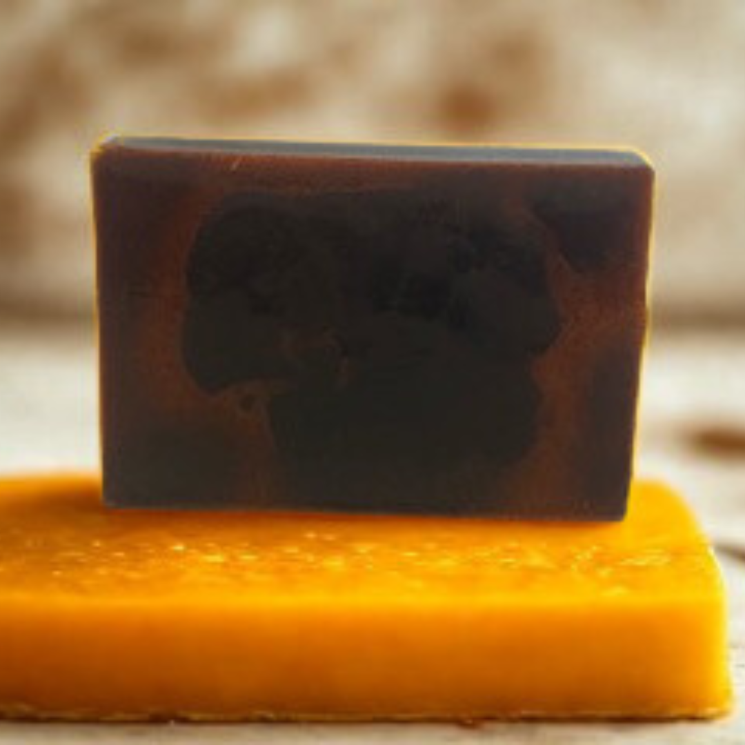 Golden Glow Turmeric Handmade Soap on a yellow sponge with a blurred background