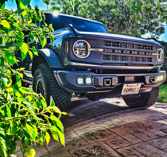 Front view of a Ford Bronco SUV parked on a brick driveway with  Fog Light.