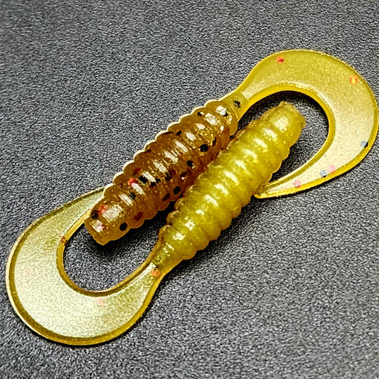 Yellow fishing lure with a hook on a gray background