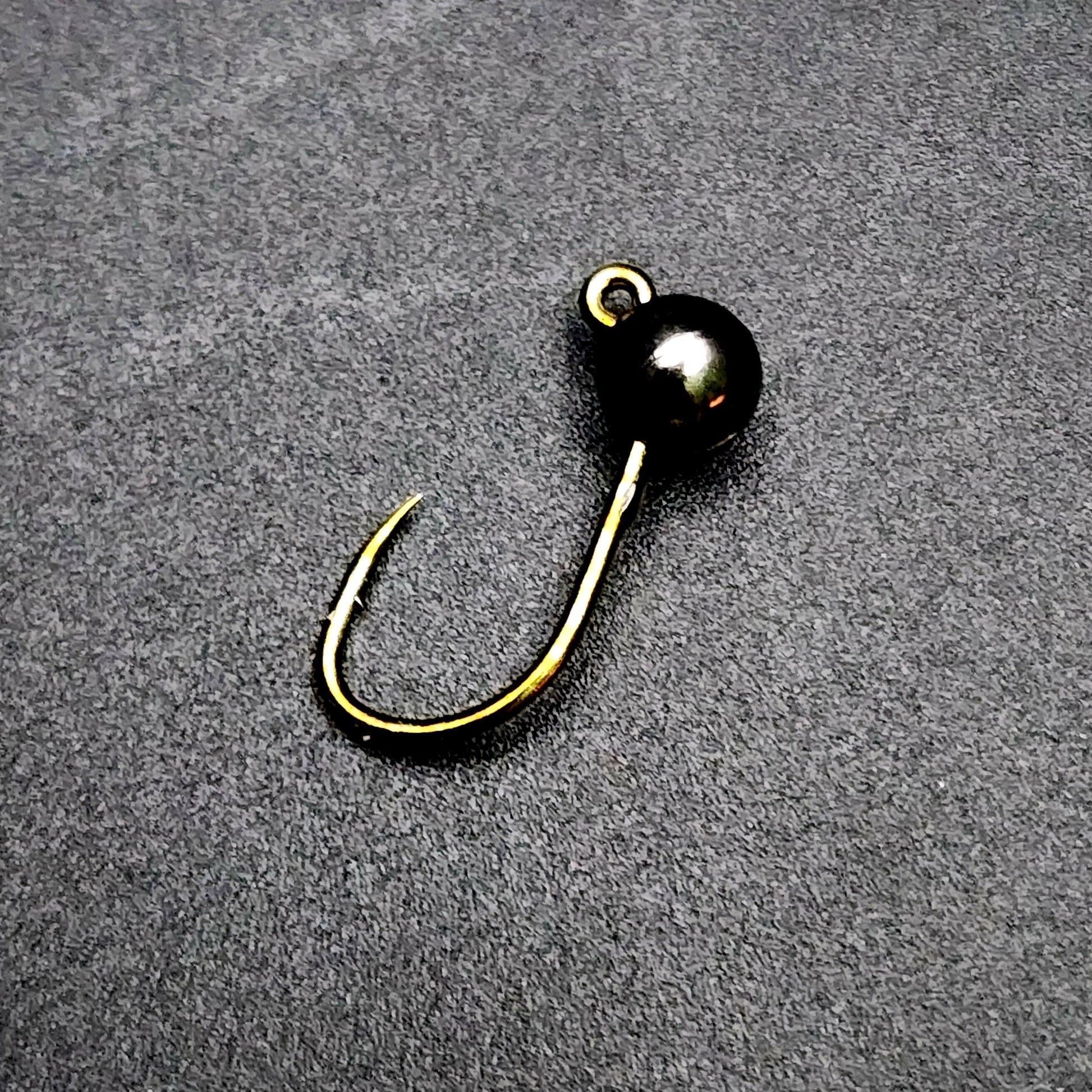 Fishing hook jig on a gray surface