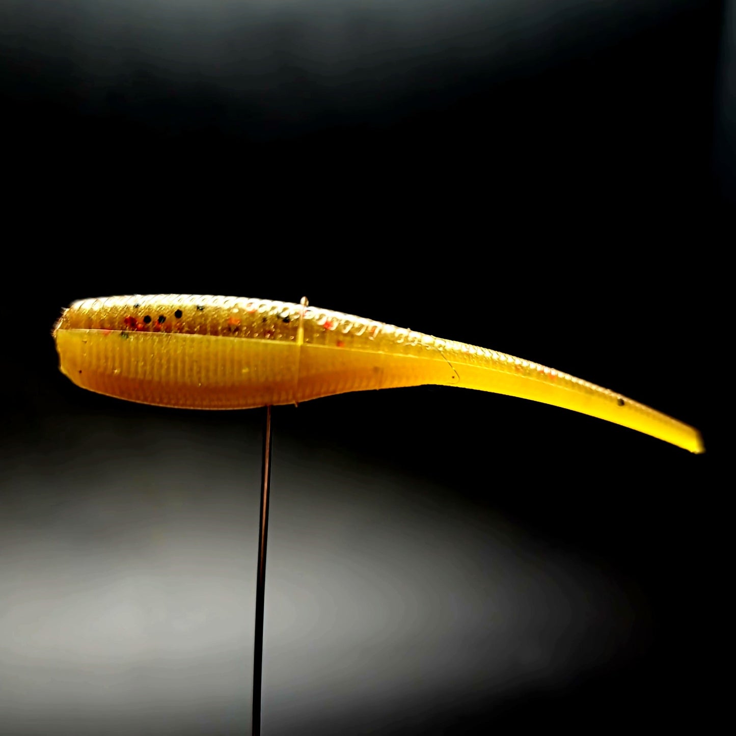Yellow fishing lure on a black background