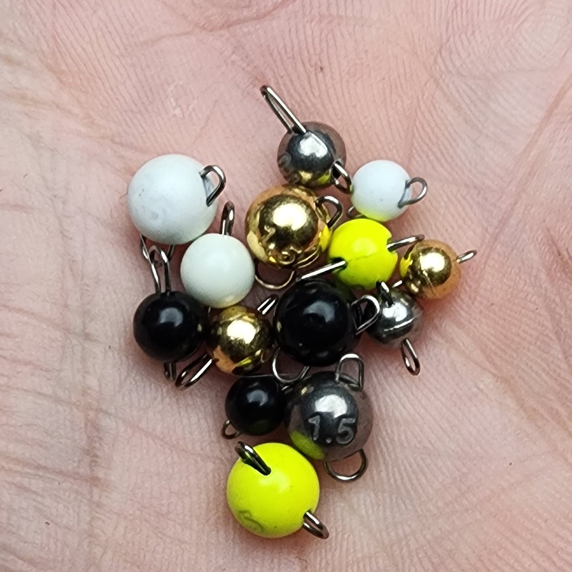 Assorted fishing sinkers on a hand