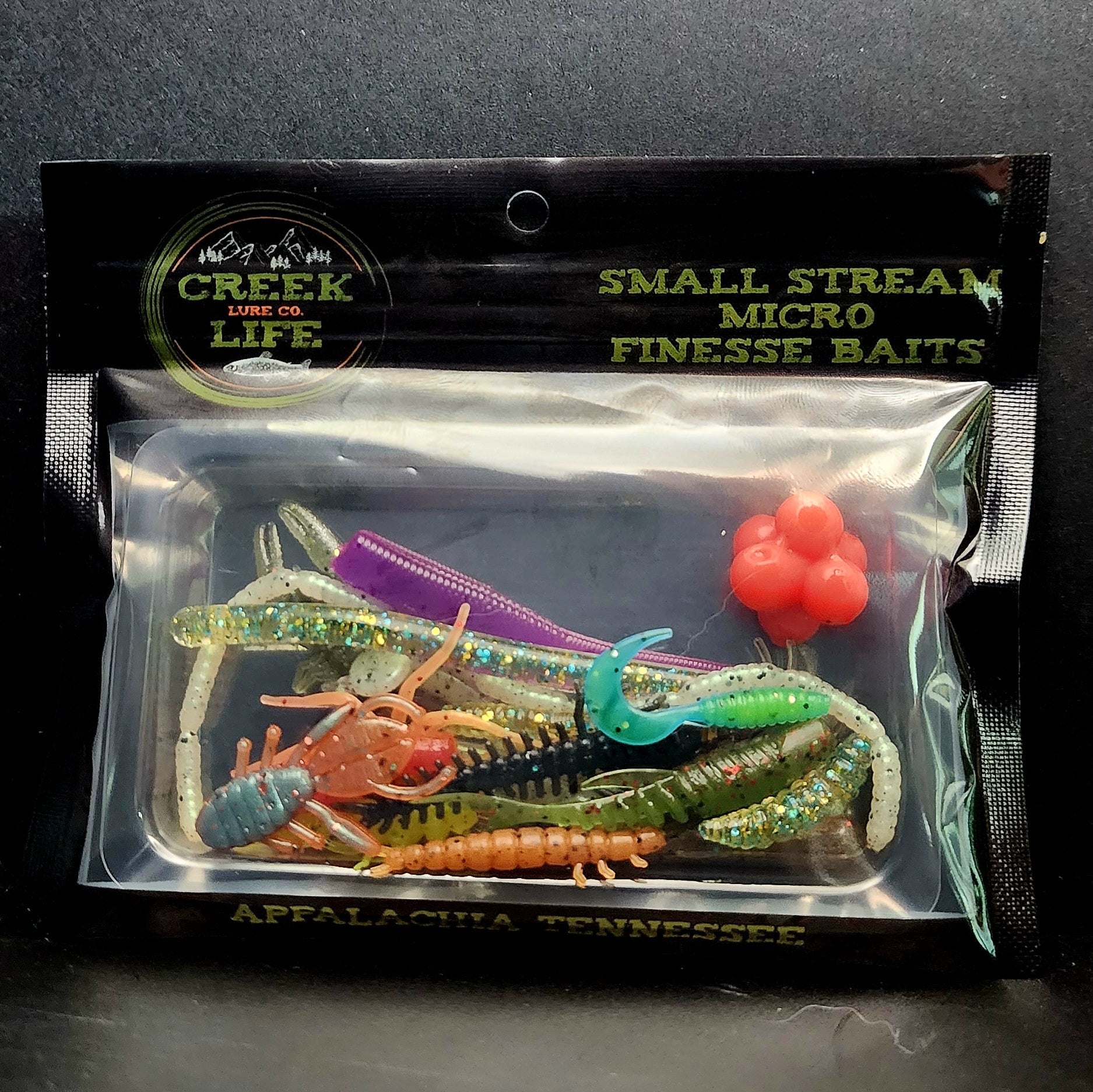 Packaged small stream micro finesse baits with Creek Lure Co. branding on a dark background.