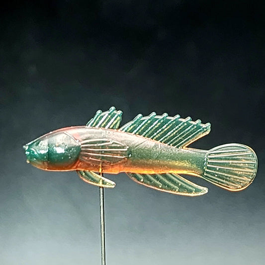 Fish-shaped lure on a dark background