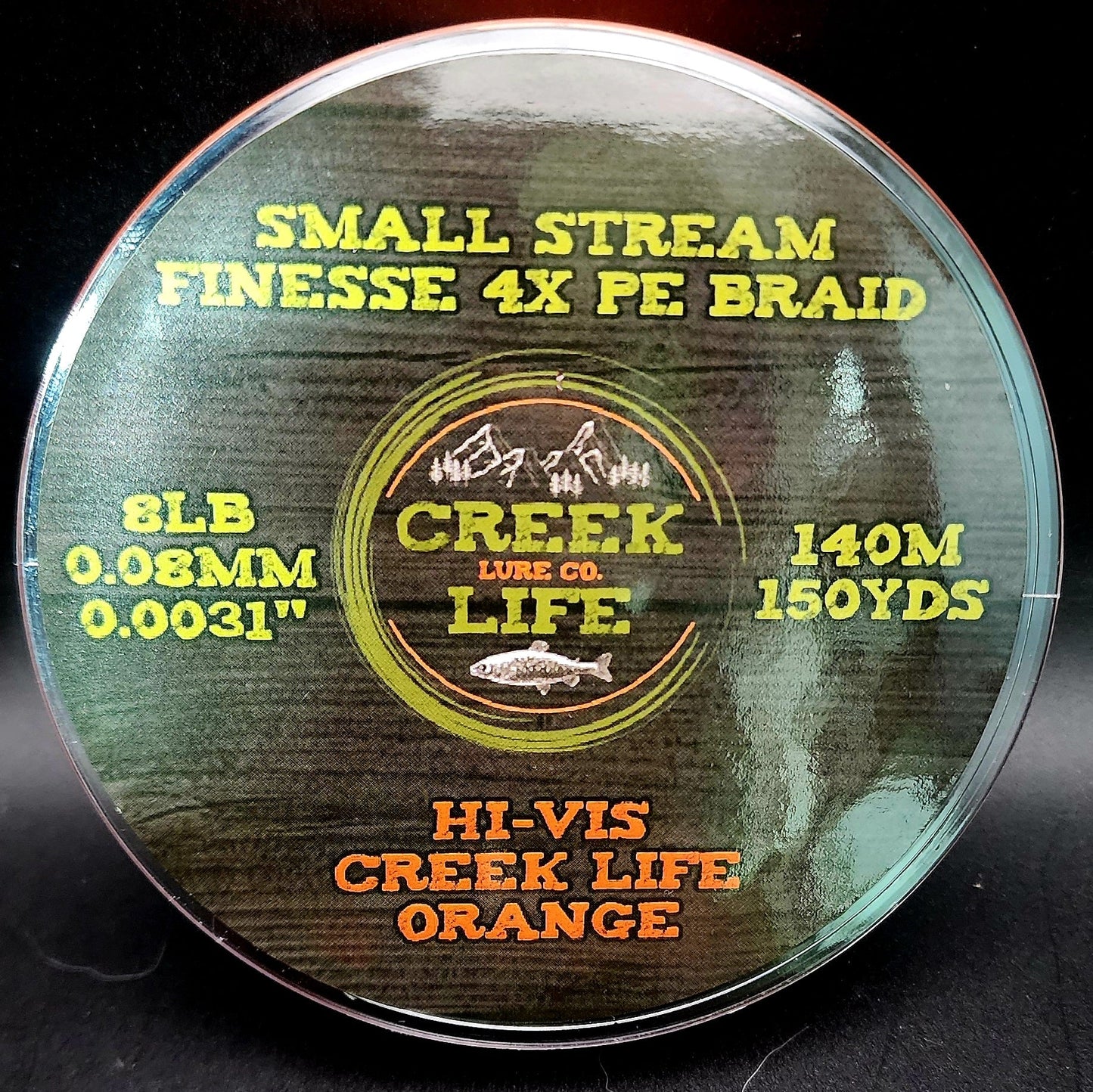 Fishing line spool with 'Creek Lure Co.' branding on a dark background