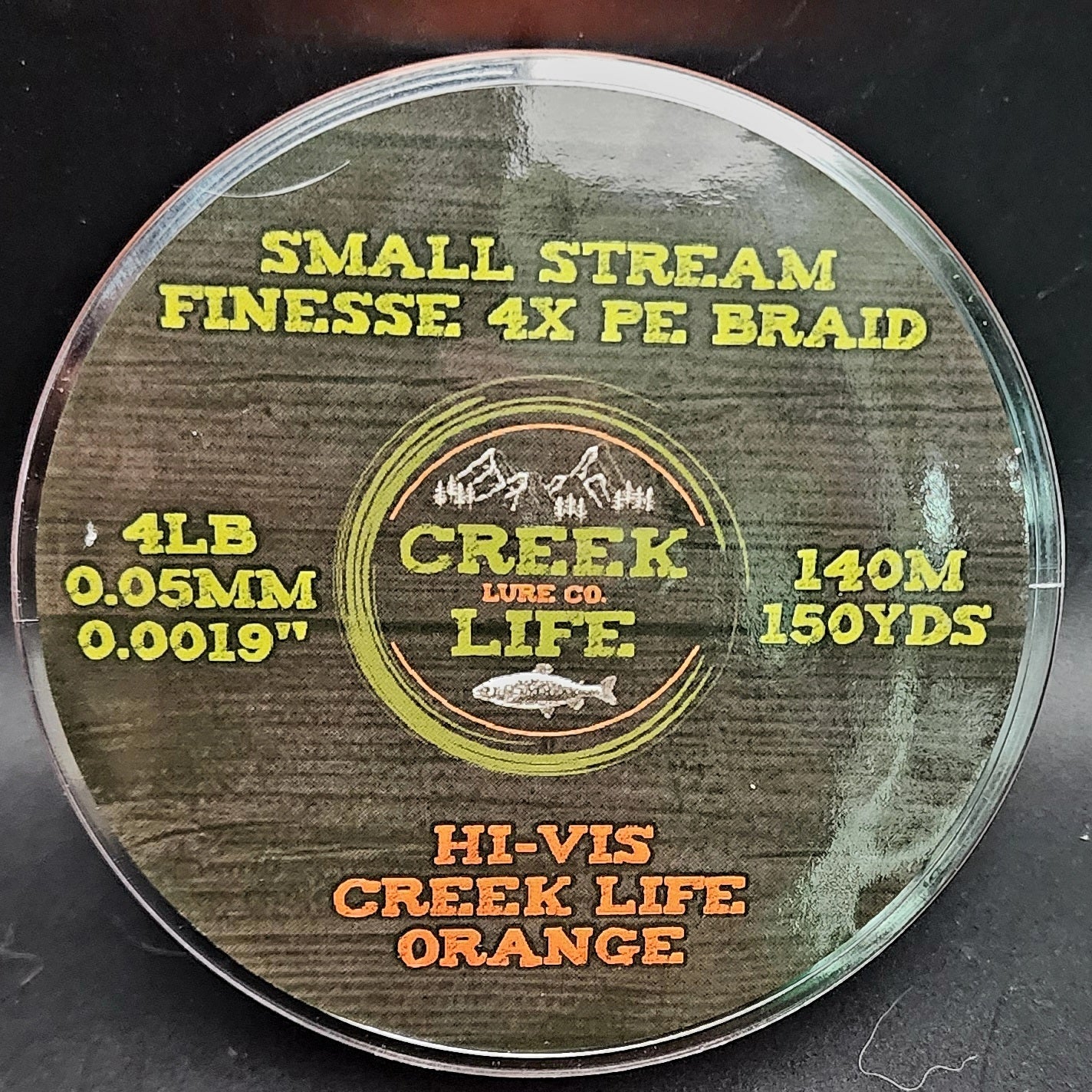 Fishing line spool with 'Creek Lure Co. Life' branding on a dark background