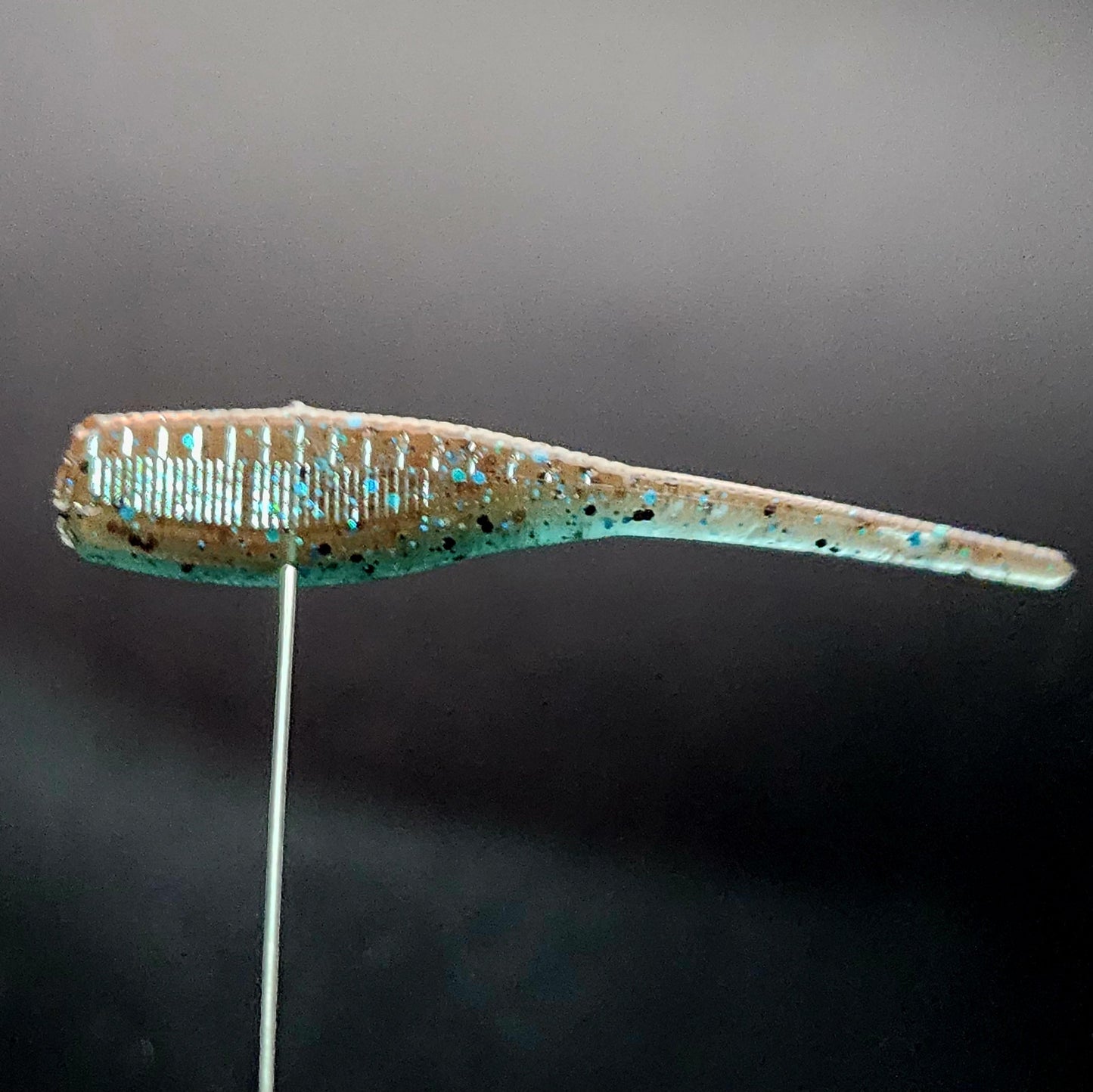 Fishing lure on a stand against a dark background