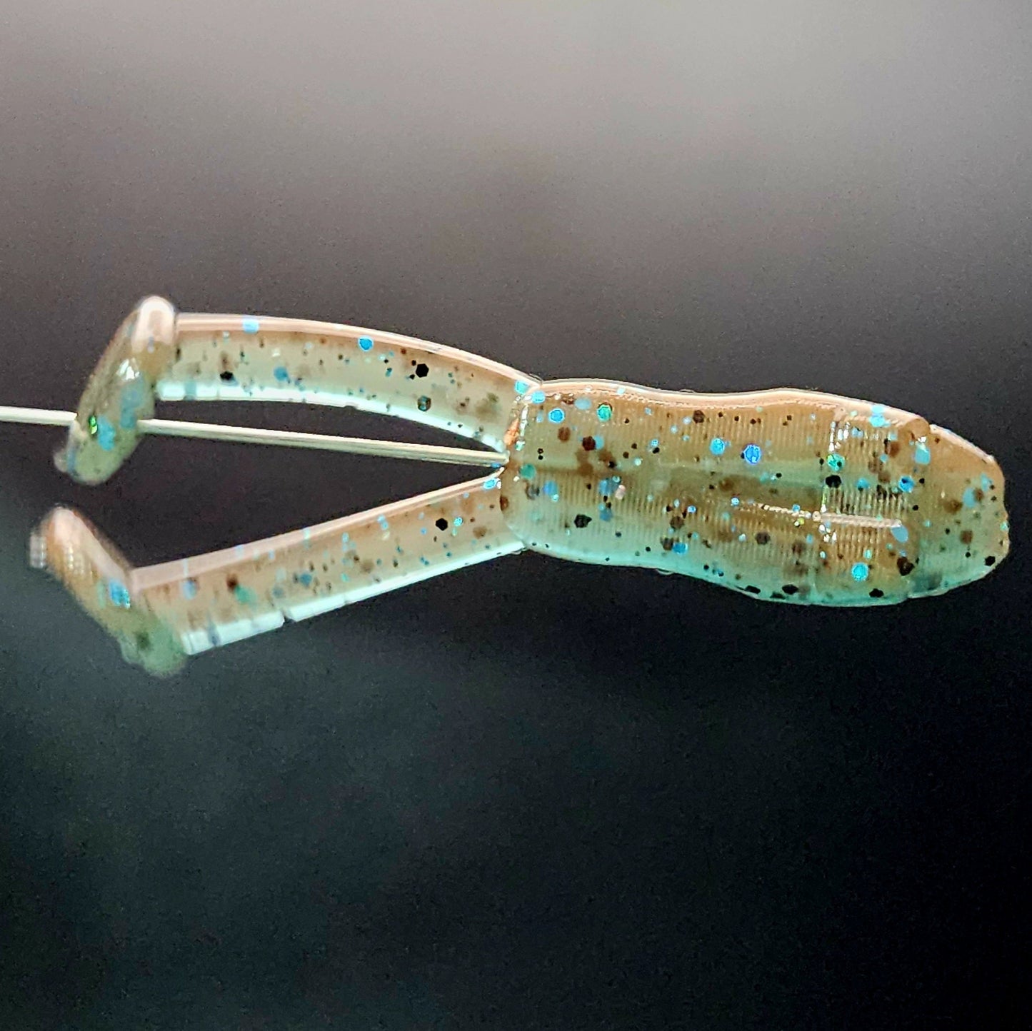 Fishing lure with glittery texture on a dark background