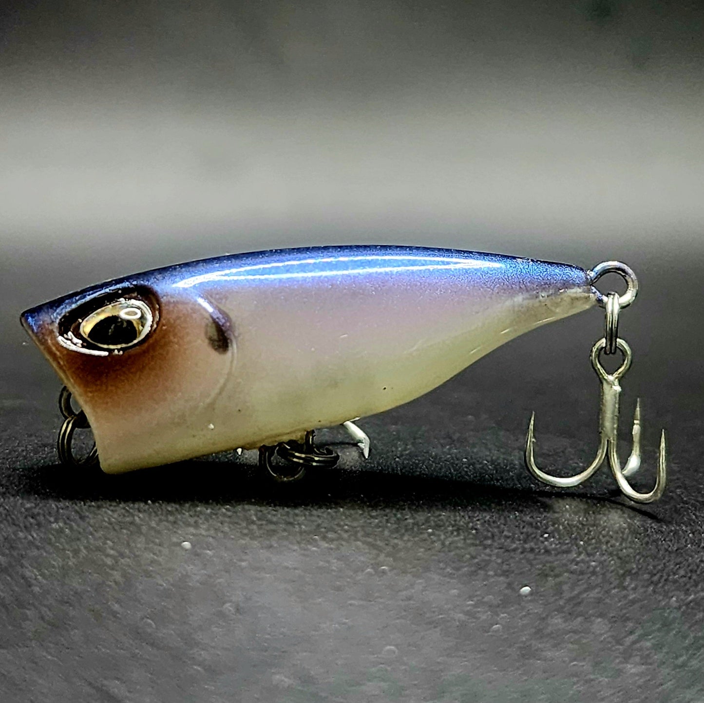 Fishing lure with a hook on a dark surface