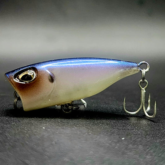 Fishing lure with a hook on a dark surface