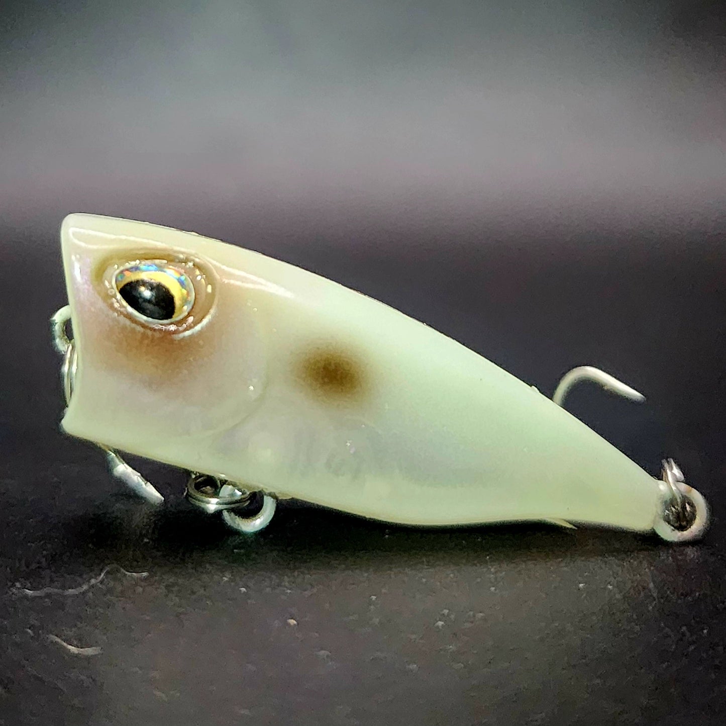 Fishing lure with a detailed design on a dark background