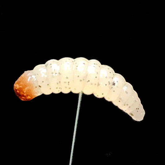 White larva fishing lure on a black background