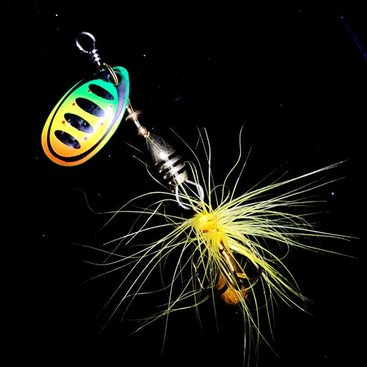 Fishing lure with a colorful body and yellow skirt on a black background