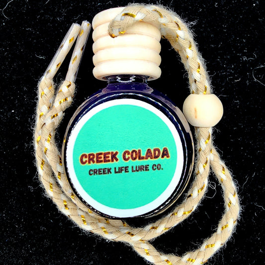 Bottle of 'Creek Colada' by Creek Life Lure Co. with braided rope on a black background