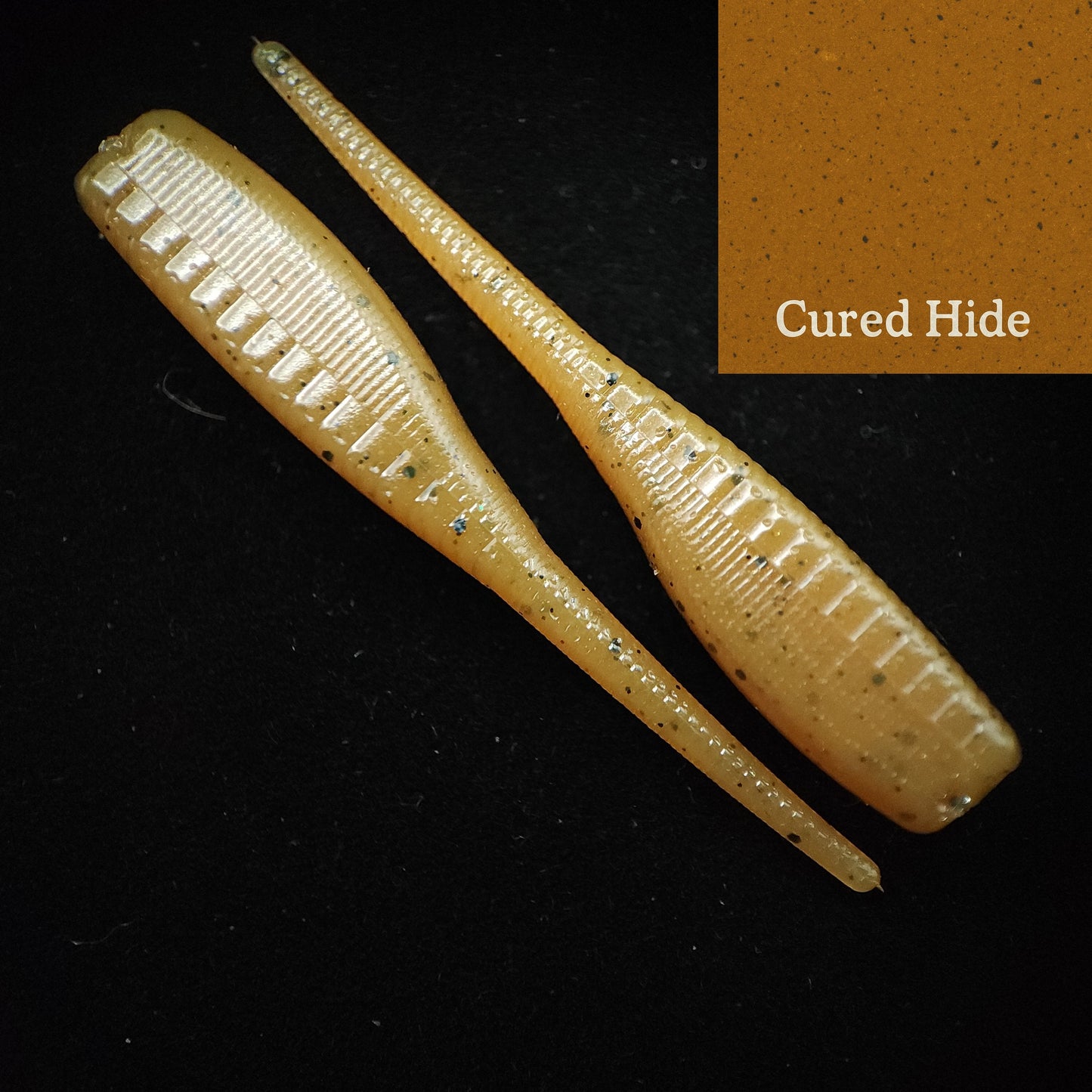 Two cured hide fishing lures on a black background with 'Cured Hide' text 