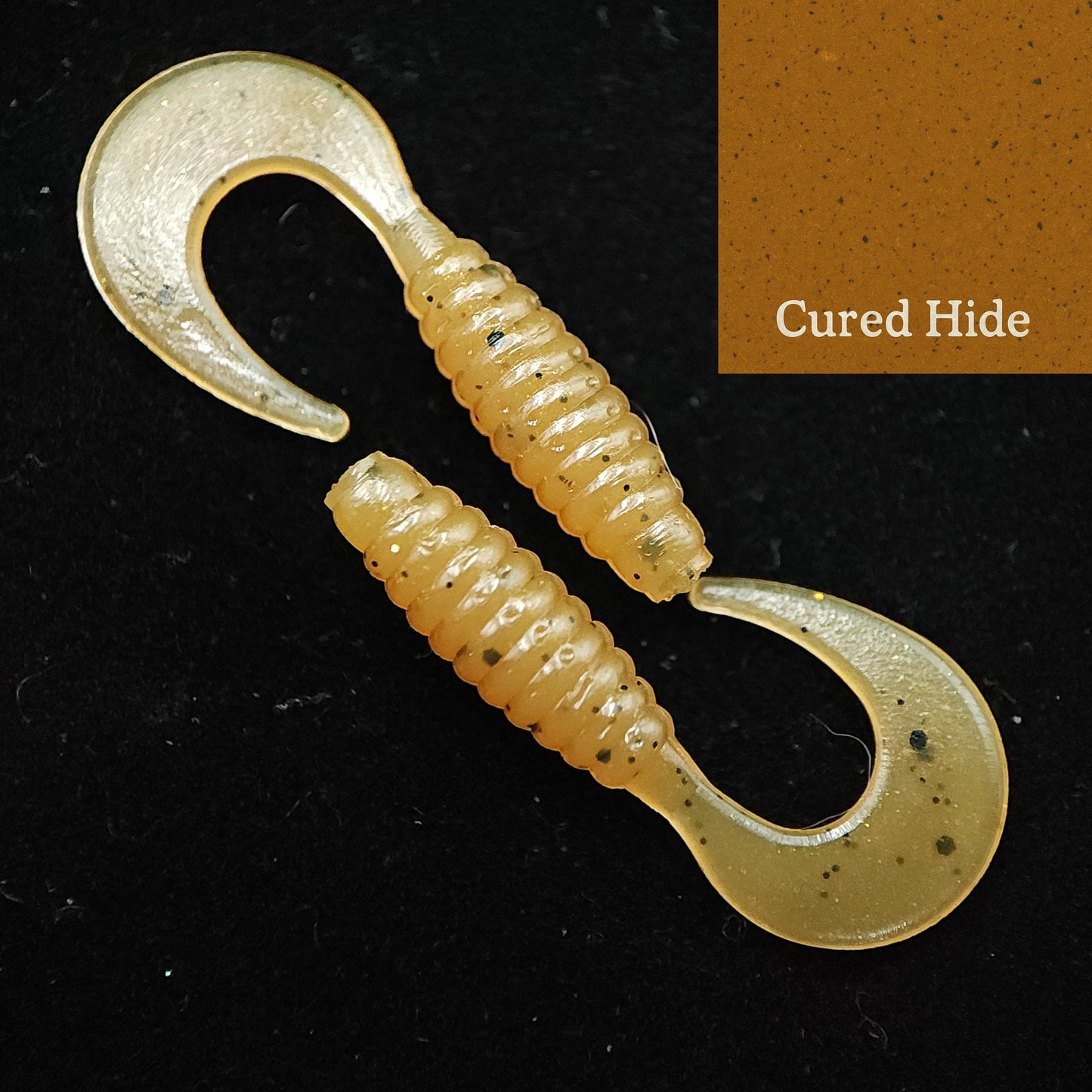 Fishing lure with 'Cured Hide' label on a black background