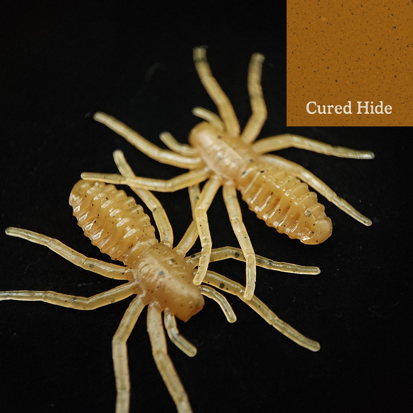 Two spider-like lures on a black background with 'Cured Hide' text.