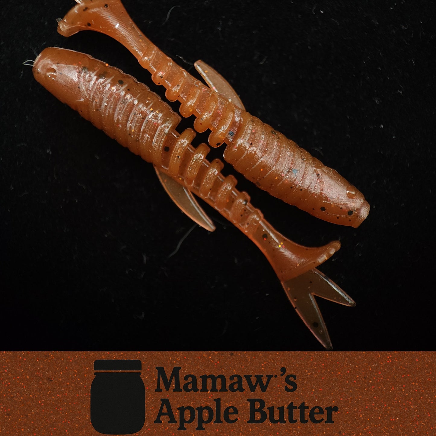 Two brown fishing lures on a black background with 'Mamaw's Apple Butter' logo.