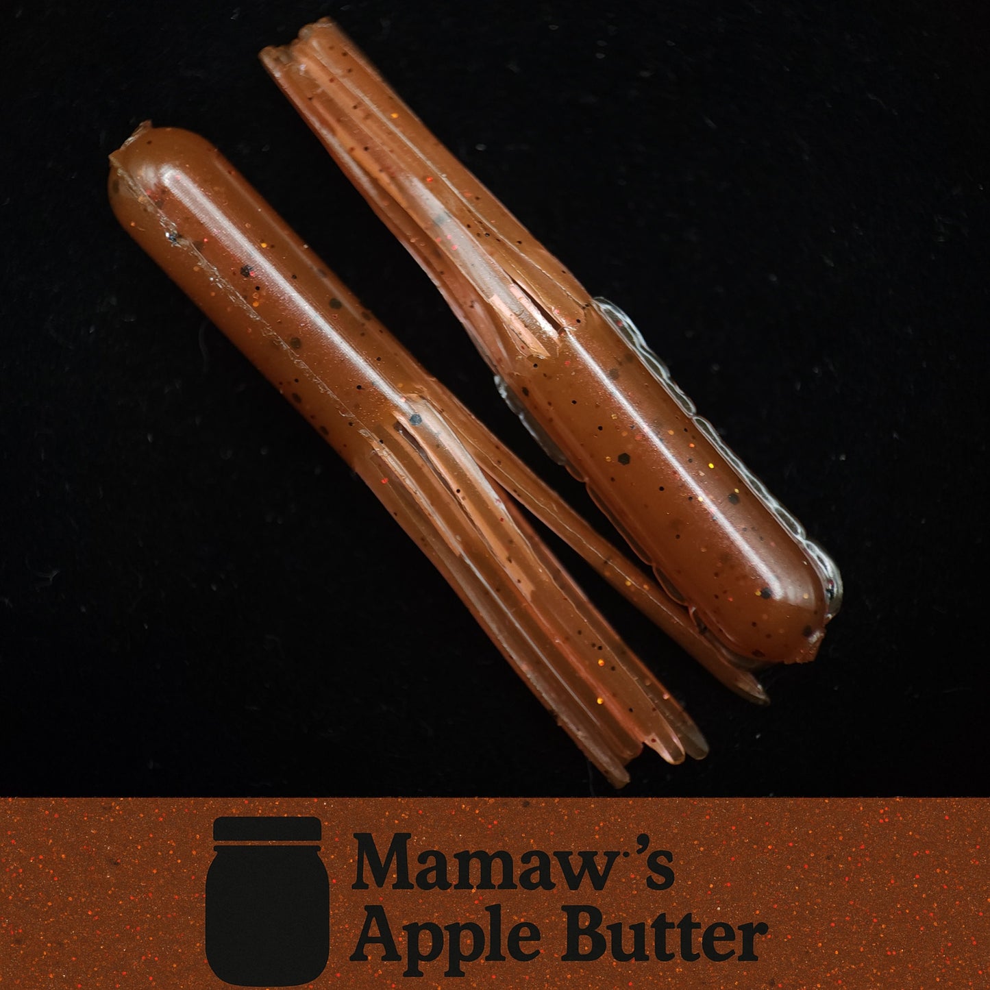 Two brown fishing lures on a black background with 'Mamaw's Apple Butter' branding.