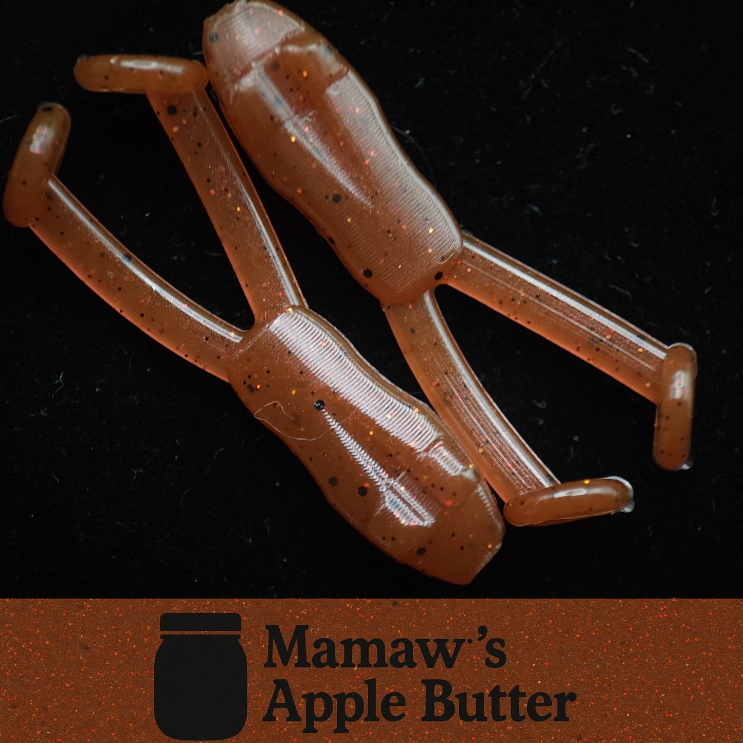 Two brown plastic lures on a black background with 'Mamaw's Apple Butter' branding.