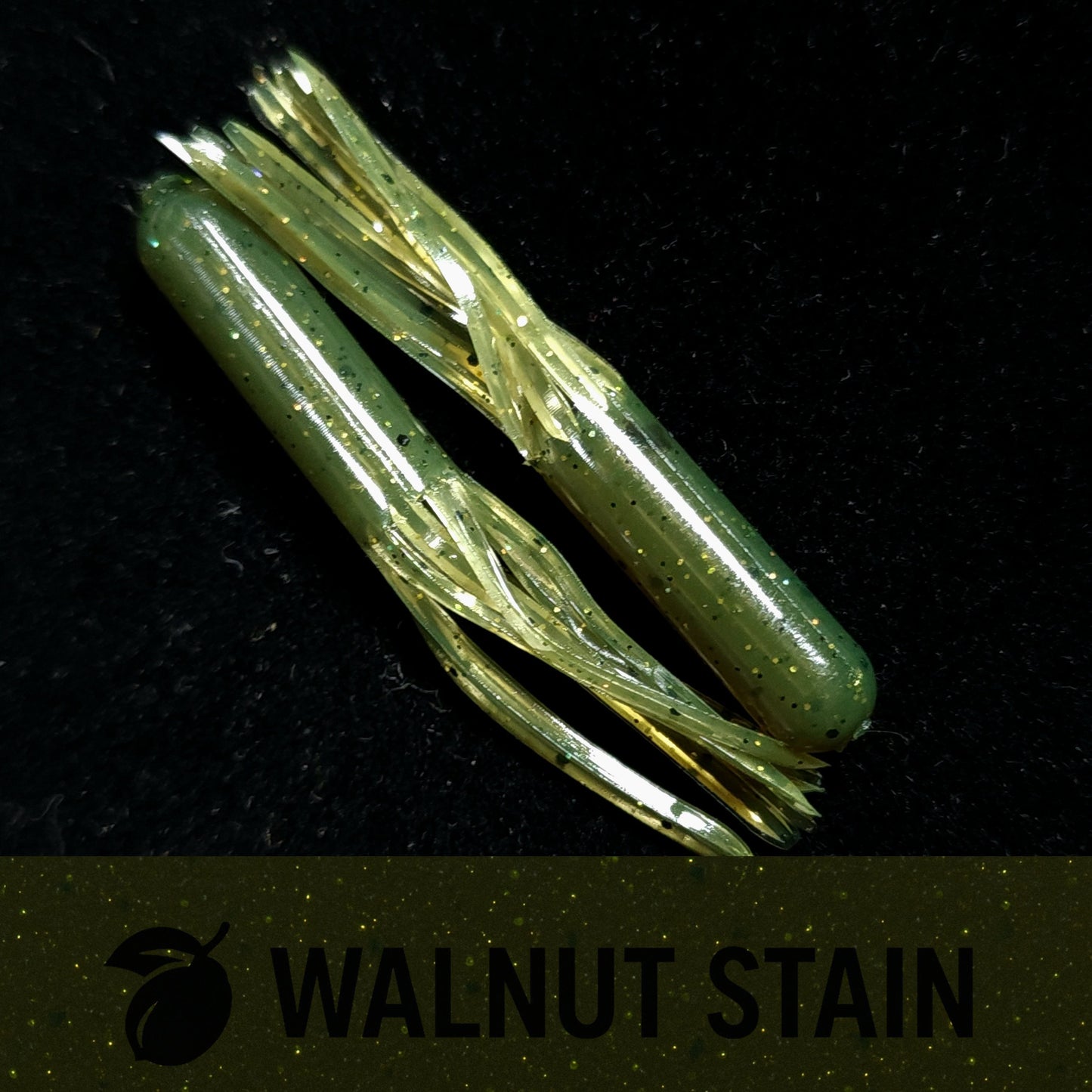 Two green fishing lures on a black background with 'Walnut Stain' text.