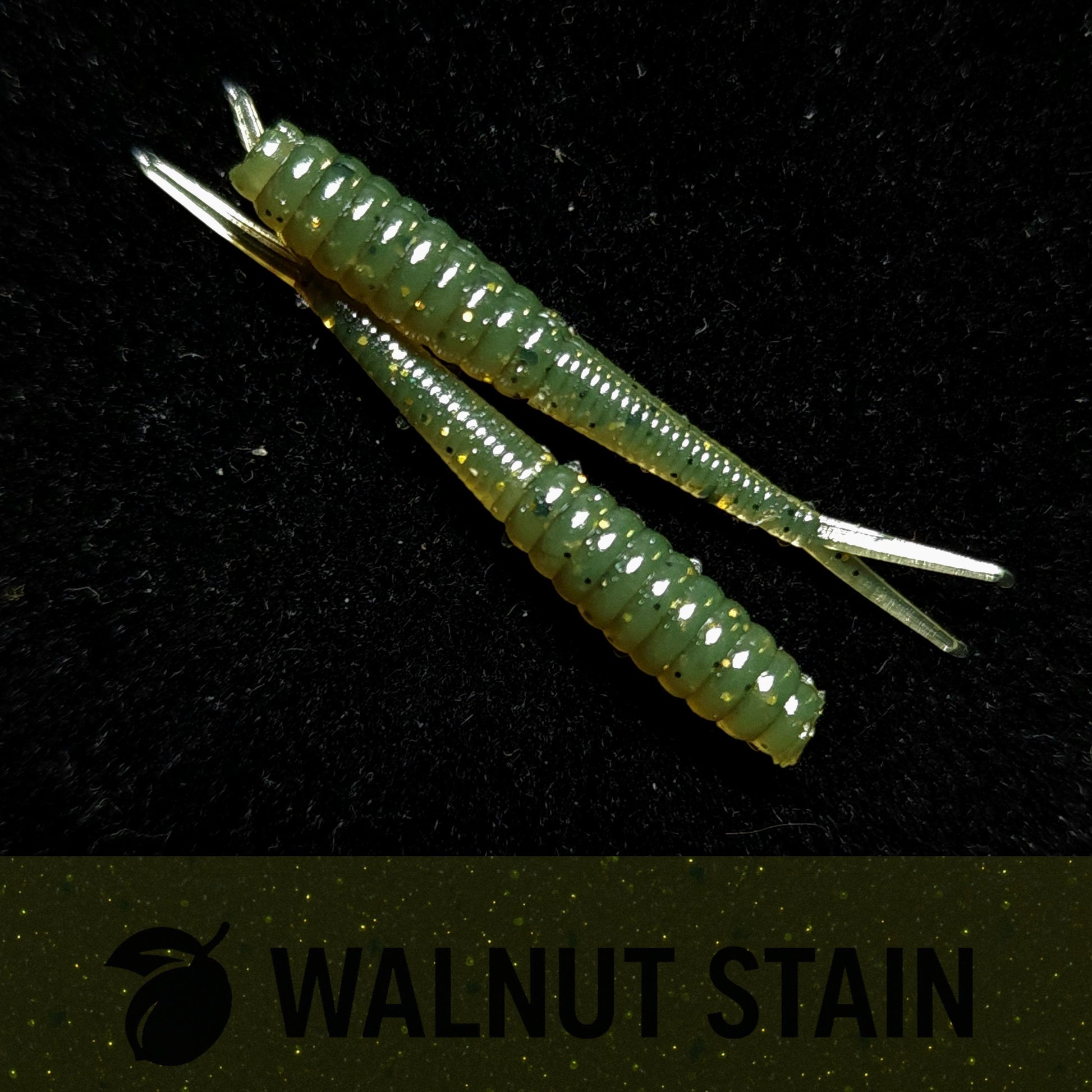 Two green fishing lures on a black background with 'Walnut Stain' branding.