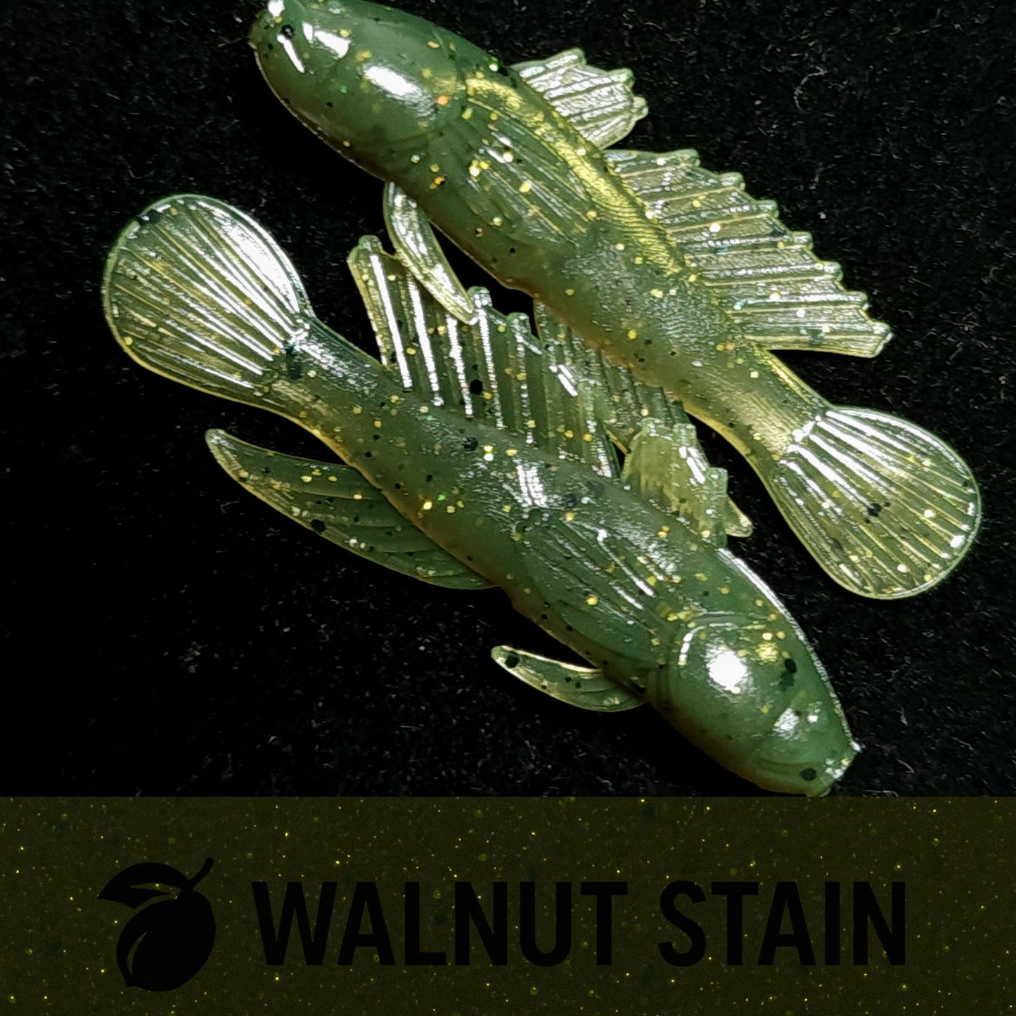 Two green fishing lures with a walnut stain finish on a black background