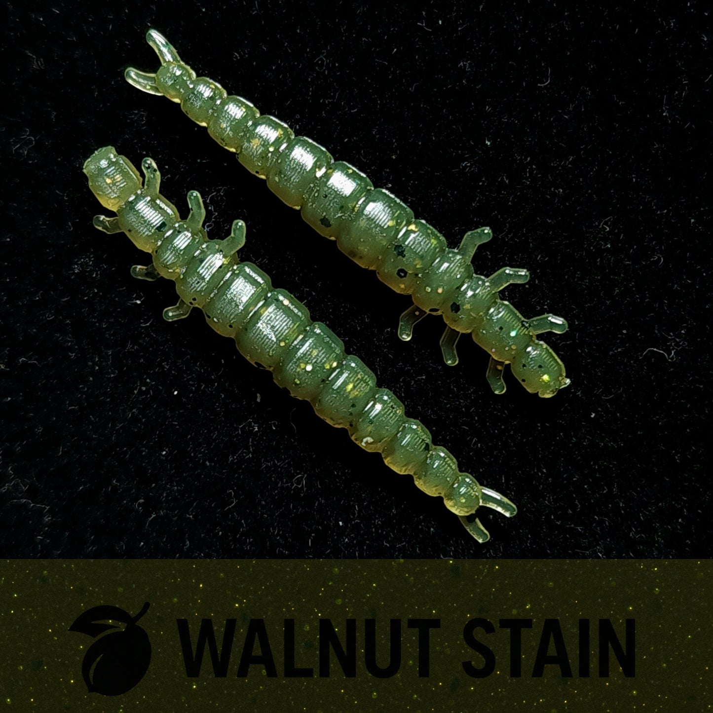Two green fishing lures on a black background with 'Walnut Stain' branding.