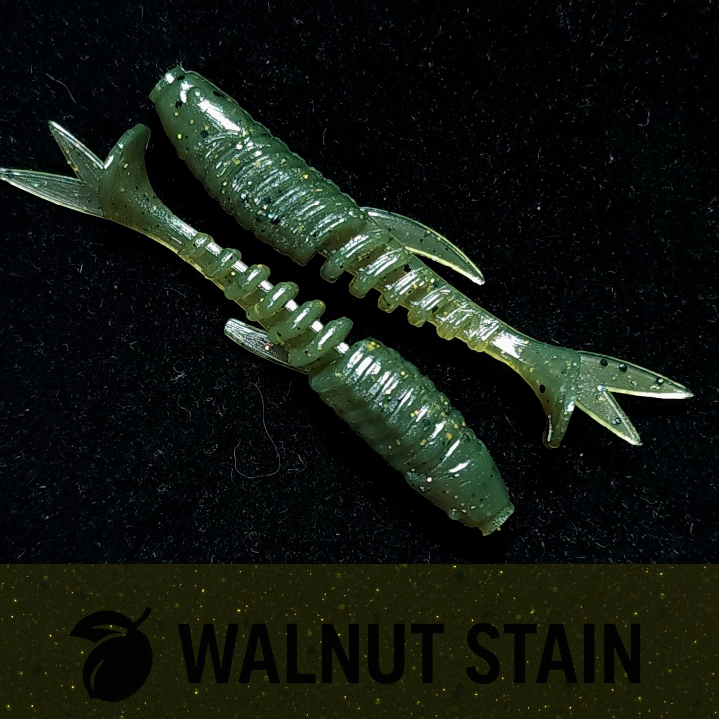 Green crawfish-shaped fishing lure on a black background with 'Walnut Stain' branding.