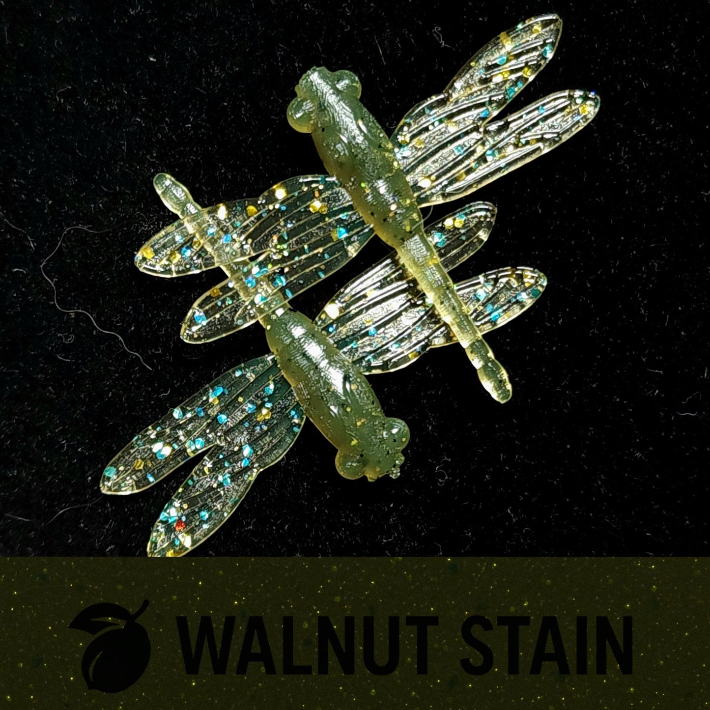 Artificial dragonfly with glittery wings on a black background, labeled 'Walnut Stain'.