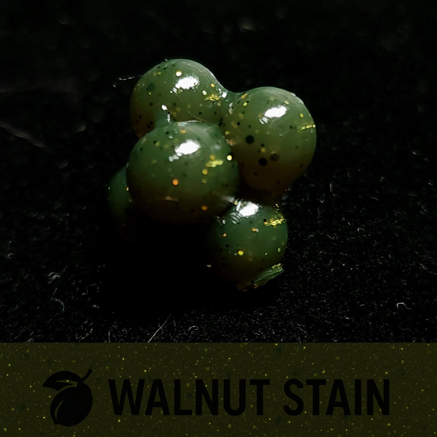 Green Salmon Egg Cluster Fishing Lure on a dark surface with 'Walnut Stain' branding.