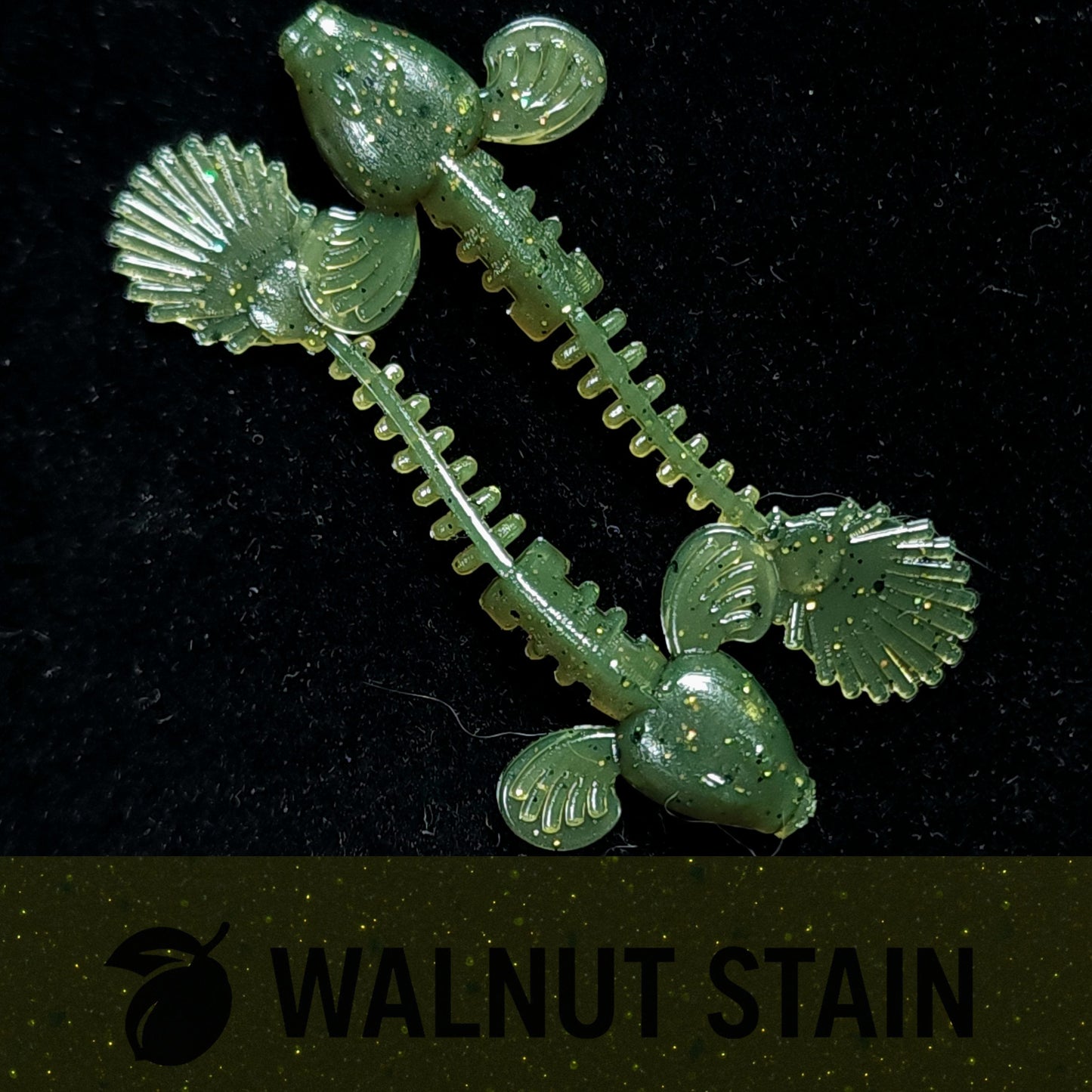 Green fishing lure with a detailed design on a black background, labeled 'Walnut Stain'.