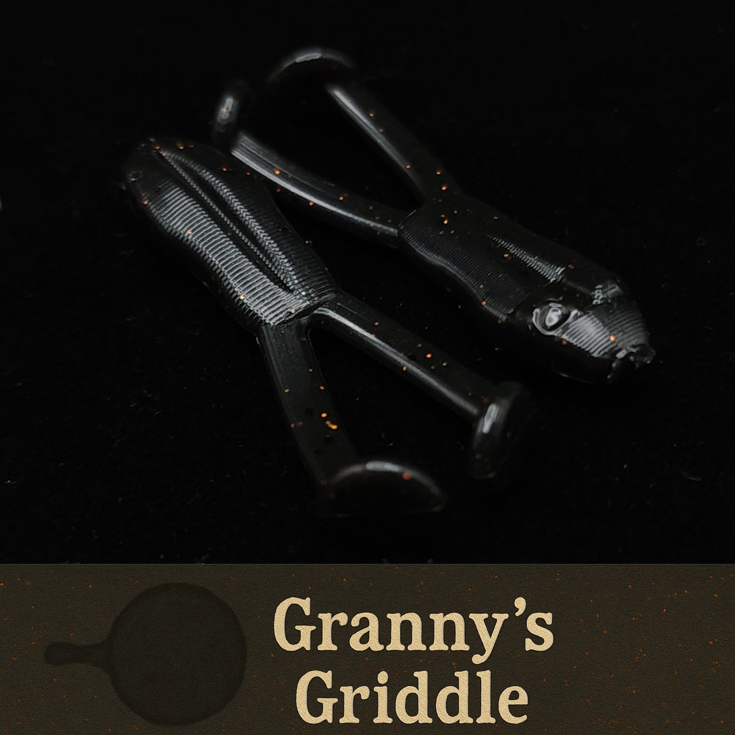 Black frog shaped fishing lures on a dark background with 'Granny's Griddle' branding.
