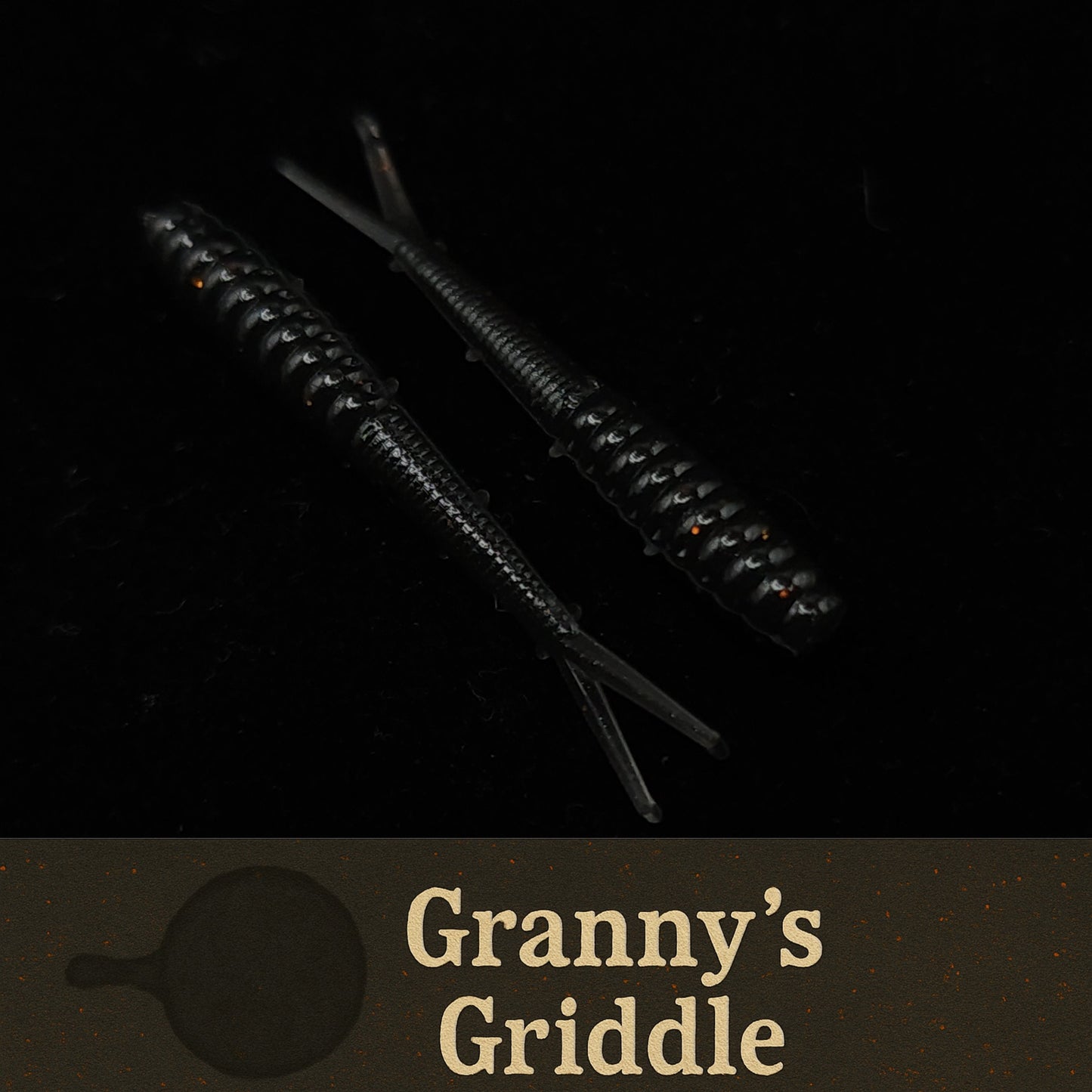 Two black  fishing lures on a dark background with 'Granny's Griddle' branding.