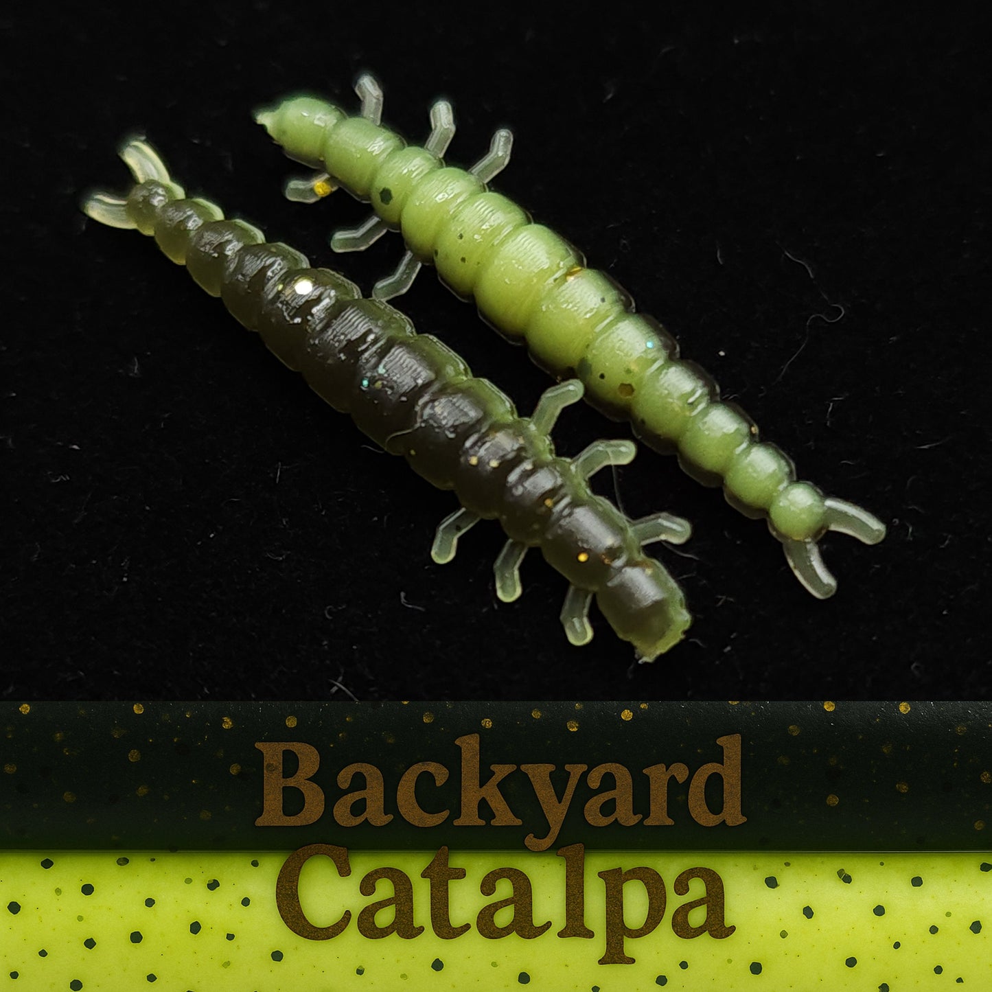 Two green and brown caterpillar-shaped fishing lures on a black background with 'Backyard Catalpa' branding.