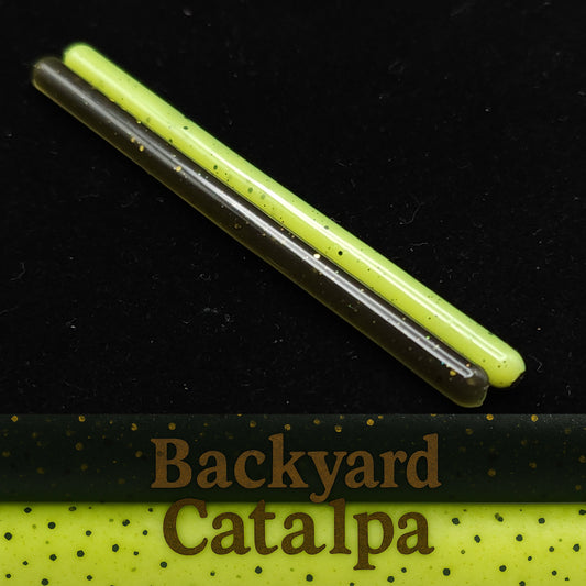 Two fishing lures with 'Backyard Catalpa' branding on a black background