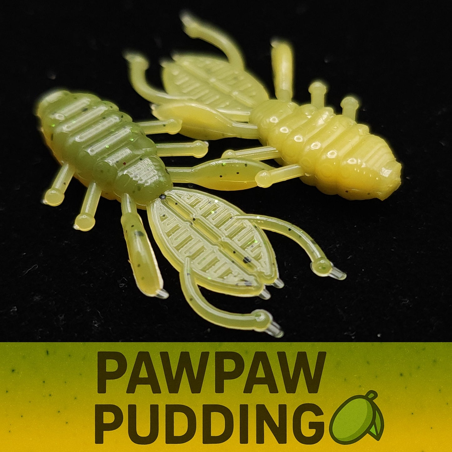 Two green and yellow crawfish-shaped fishing lures on a black background with 'Pawpaw Pudding' text.