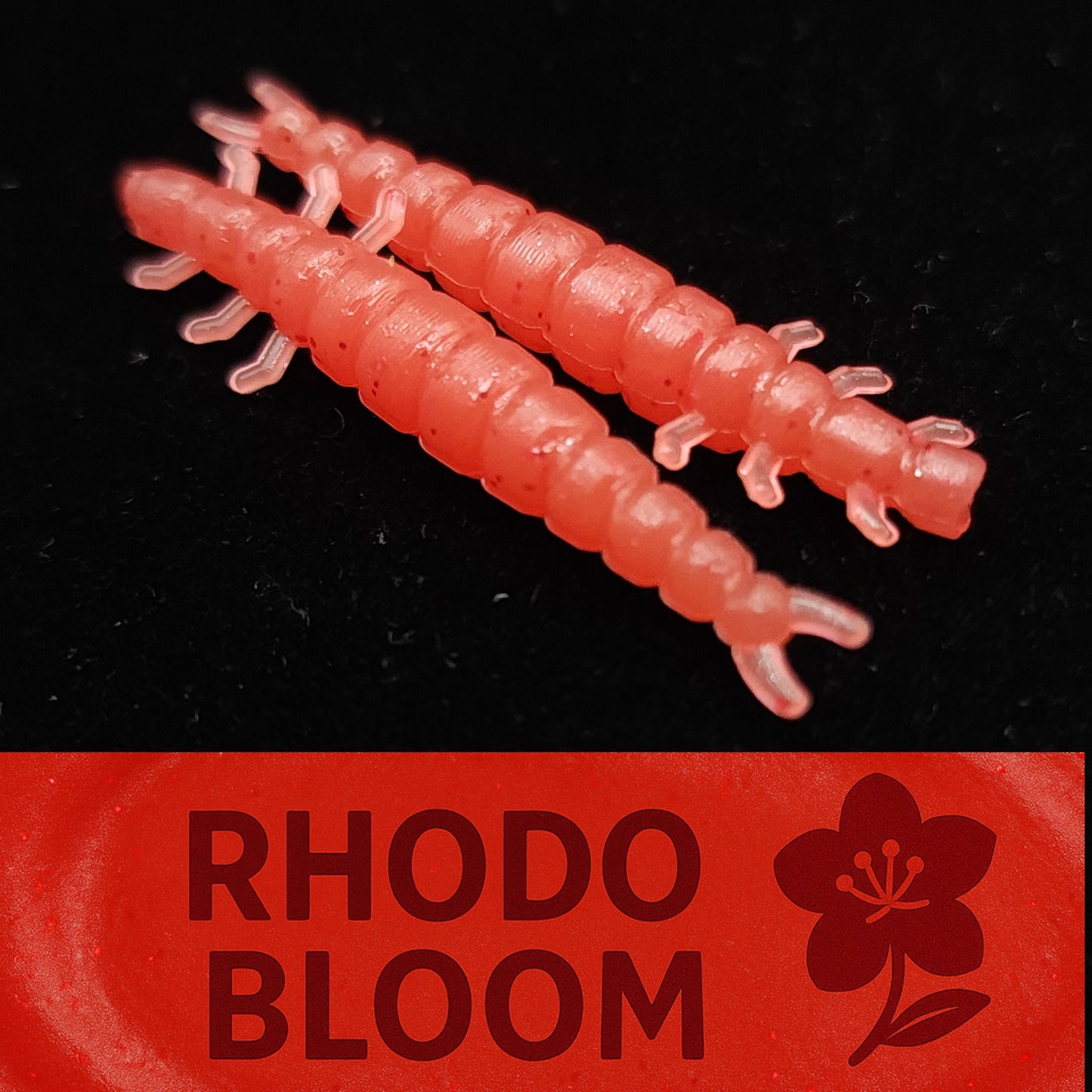 Two pinkish-red fishing lures on a black background with 'Rhodo Bloom' branding.