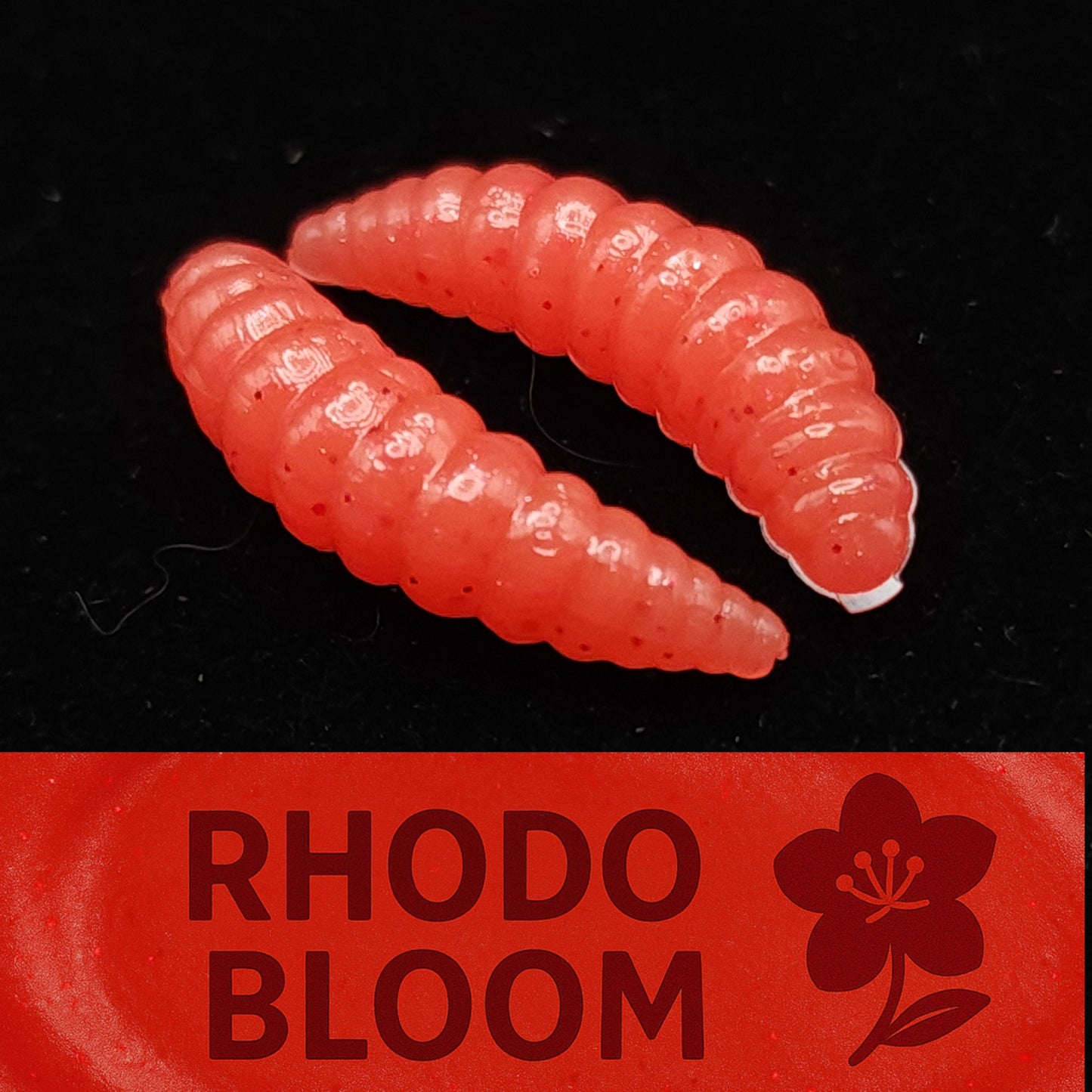 Red fishing lure with 'Rhodo Bloom' branding on a black background