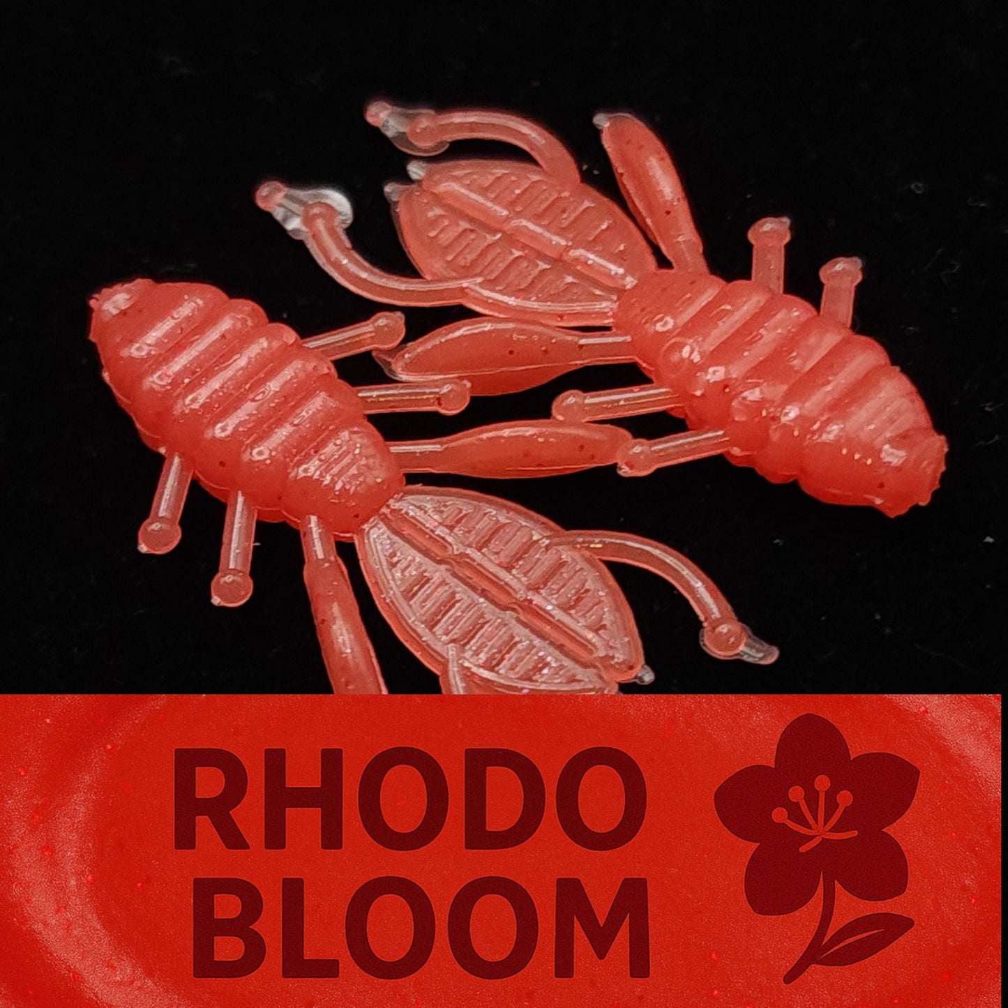 Red plastic bug fishing lures with 'Rhodo Bloom' branding on a black background